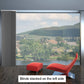 Blackout sliding panel blinds covering large window with cordless design and custom fit