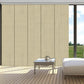 Blackout sliding panel blinds covering large sliding glass doors in a modern room