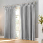 Pair of black faux linen blackout curtains with pencil pinch pleats hanging on a curtain rod