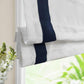No-drill blackout white fabric lined cordless Roman shade installed on a window with custom fit