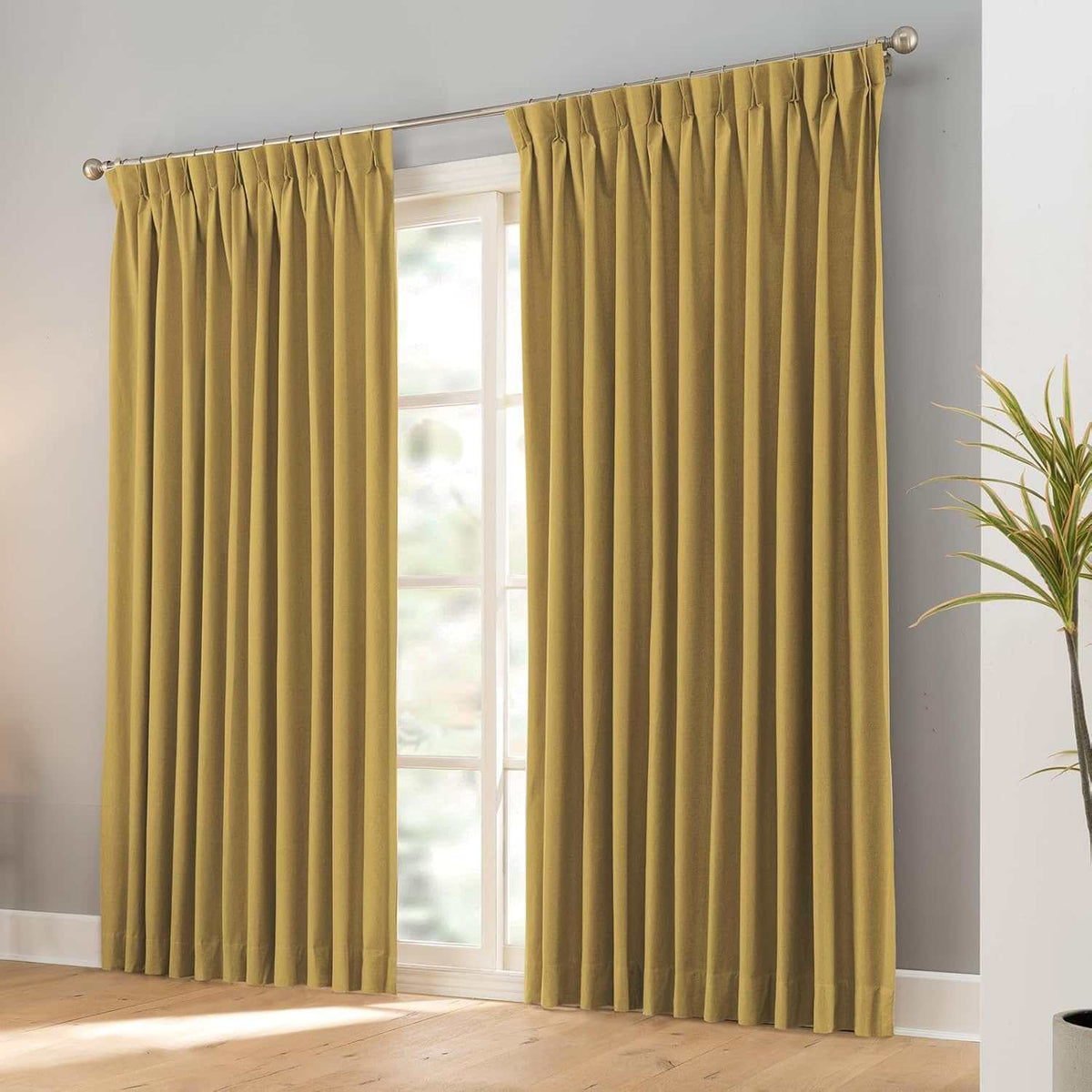 Pair of black faux linen blackout curtains with pencil pinch pleats blocking 100% light