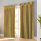Pair of black faux linen blackout curtains with pencil pinch pleats blocking 100% light